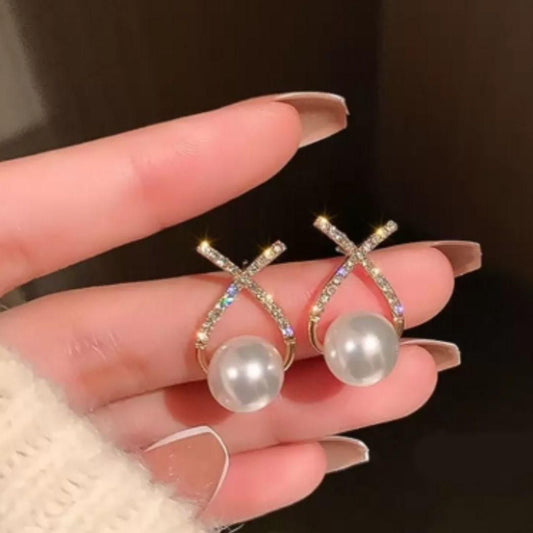Korean style gold-plated stud earrings with sparkling cross design, studded stones, and pearl embellishments for elegant fashion and party wear
