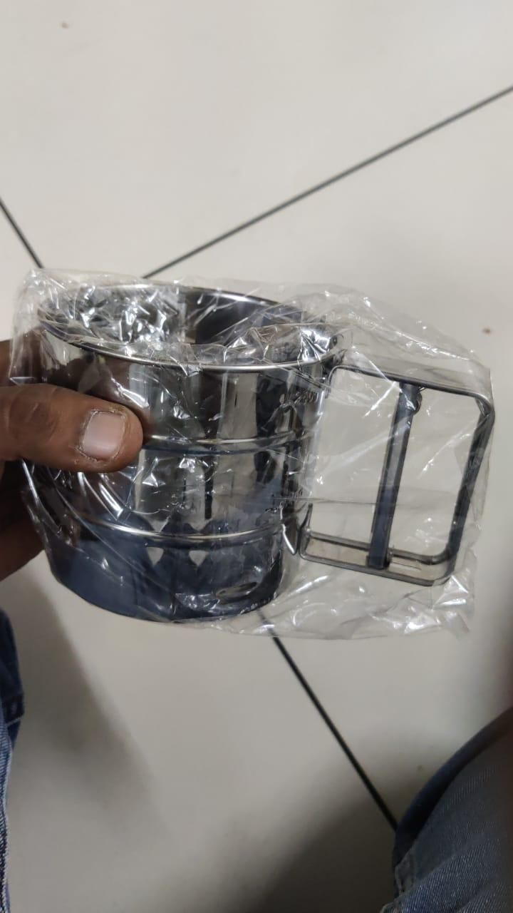 Stainless steel flour sifter in packaging with manual handle, ideal kitchen tool for sifting flour, sugar, and cocoa powder for baking and cooking