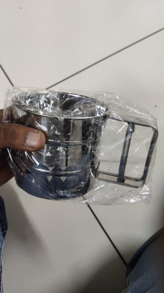 Stainless steel flour sifter in packaging with manual handle, ideal kitchen tool for sifting flour, sugar, and cocoa powder for baking and cooking